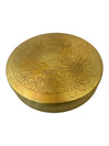 Round brass pooja box lid with floral peacock-style engraving, embossed gold finish