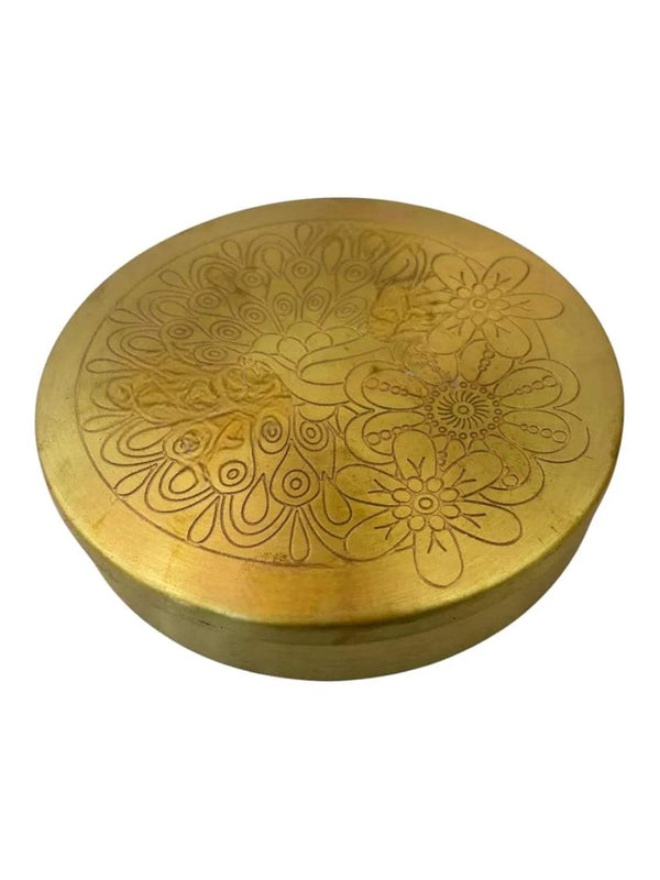 Round brass pooja box lid with floral peacock-style engraving, embossed gold finish