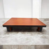 Wooden pooja chowki on four legs, rectangular top with wood grain