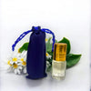 Blue drawstring pouch and small gold-capped glass attar bottle with clear liquid