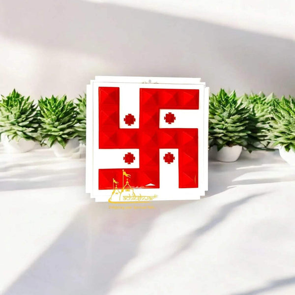 Red swastik-style pyramid wall hanging with raised geometric tiles, white backing