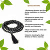 Black tulsi bead meditation mala with hanging tassel, looped around