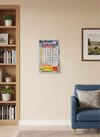 Wall-hanging calendar mounted on wall above rug, with colorful date grid