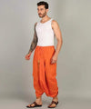 Orange cotton dhoti with pocket, front view with gathered ankle cuffs