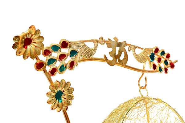 Golden swing arm with jeweled floral ornaments and hanging mesh ball cradle