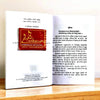 Open Hindi astrology book showing printed pages with small red cover on left