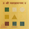 Gold yantra card with printed Devanagari numerals and geometric sections