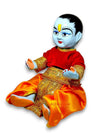 Bal Gopal idol seated, blue face, red top and orange dhoti, gold embroidery and belt