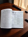 Open almanac book with dense printed text and diagram layout on both pages