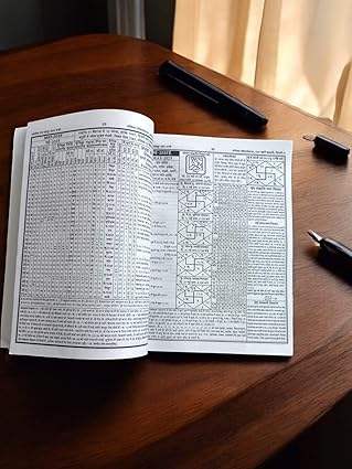 Open almanac book with dense printed text and diagram layout on both pages