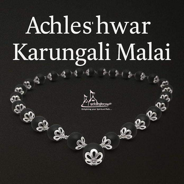 Wood mala necklace with black beads and silver-toned flower-shaped spacers