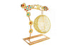 Golden decorative swing stand with hanging mesh egg cradle and jeweled flower motifs