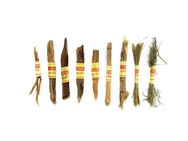 Hawan samidha wood sticks with red-yellow labels and tied grass bundles