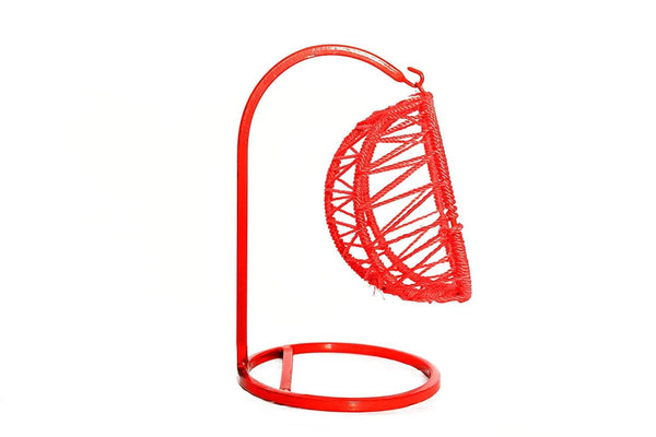 Red hanging swing with oval net cradle and circular base ring, angled view