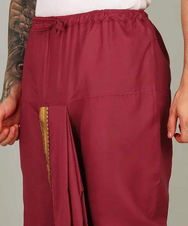 Red cotton dhoti with gold-bordered pocket opening and gathered elastic waistband.