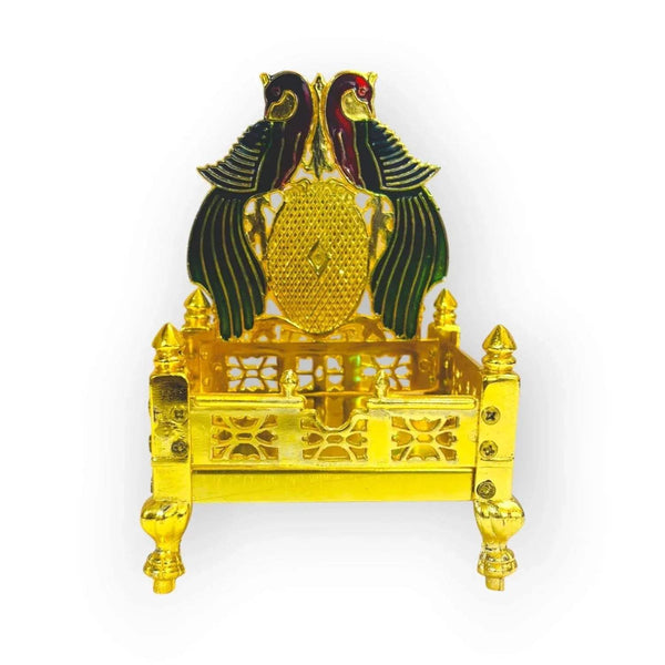 Front view of gold-plated brass singhasan with peacock wings, crest, and decorative carvings.