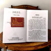 Palmistry book open pages with printed text and square AchleishaWAr spiritual path logo