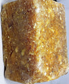 Brown-golden loban dhoop resin block with speckled texture on a flat face