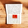 Open Hindi devotional booklet with printed pages and red spiritual logo sticker