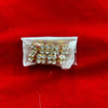 Rhinestone idol decoration strip with gold-toned setting and clear gems in plastic wrap