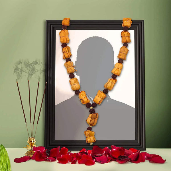 Sandalwood mala necklace, layered V-shape of carved amber beads with dark spacers