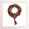 Rudraksha mala featuring brown 4mm bead strand with red tassel, coiled
