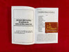Siddha Shabar Mantra book open to printed Hindi pages with gold emblem