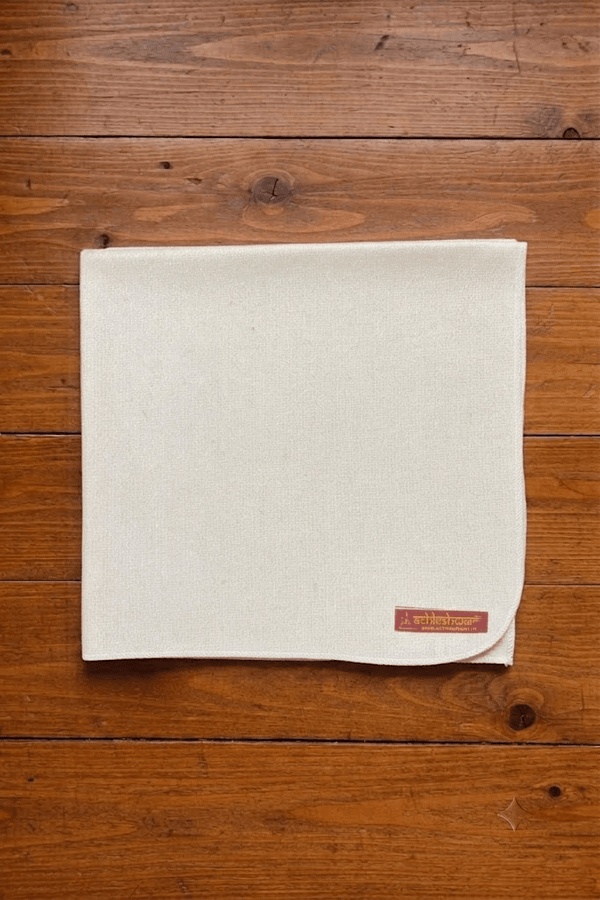 Off-white woolen pooja mat with stitched border and small label corner
