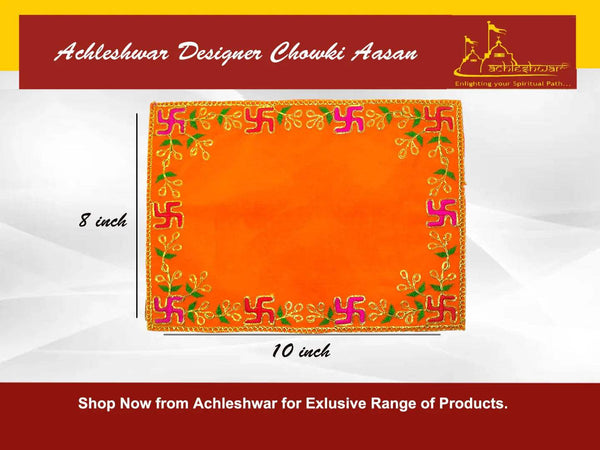 Orange velvet pooja aasan cloth featuring gold and green embroidered corner motifs