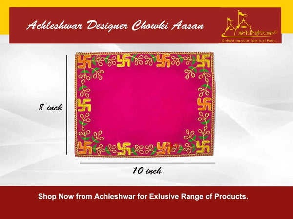 Square pink velvet pooja asan with golden border and green-gold embroidered corner motifs.
