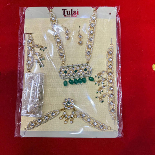 Gold-toned rhinestone and green bead shringar jewelry set with multiple matching pieces
