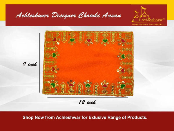 Orange velvet pooja aasan cloth with patterned gold border and green accent details