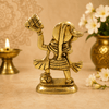 Golden Hanuman idol with raised mace and mountain, side/back view on base