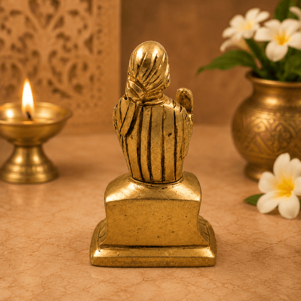Golden Sai Baba idol statue, back view with raised head and robe detailing