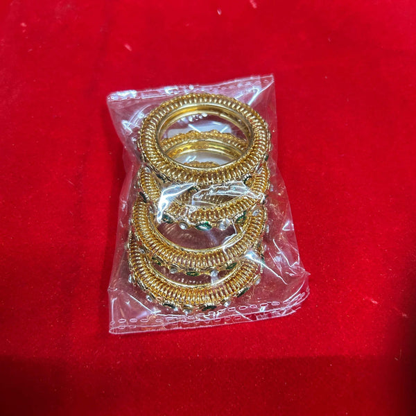 Gold-tone ornate bangles for idol decoration, in plastic wrap