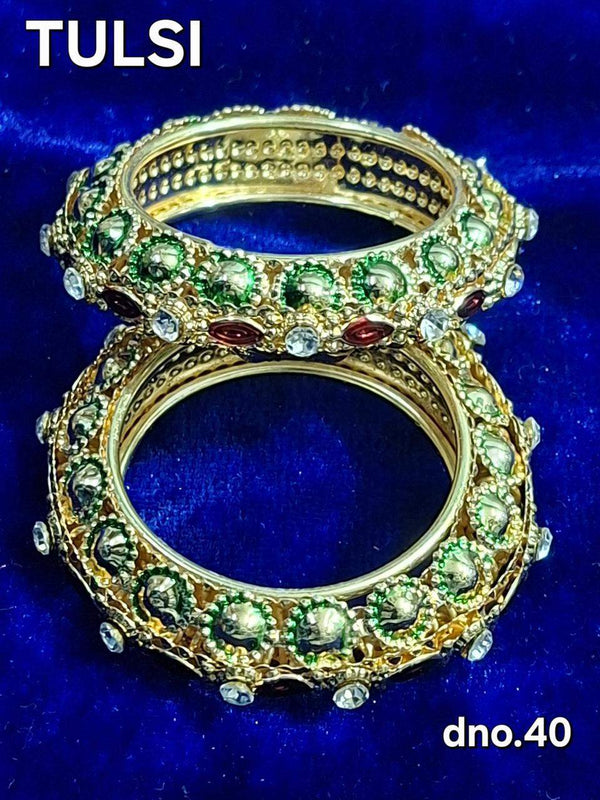 Gold bangles with green stones and red accents, ornate stacked design