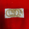 Gold bangles set with intricate filigree and thin bangles in a clear pack