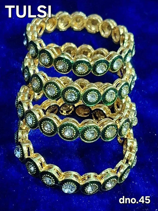 Gold-tone decorative bangles with green gemstone centers