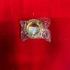 Gold-toned decorative bangle with colorful gemstone detailing, in a transparent wrapper
