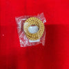 Gold-toned decorative bangle piece in clear plastic bag with bead-trim circular design