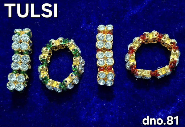Assorted gold-tone bangles with green and red stones, set of four