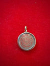 Round red etched yantra pendant locket in silver-tone frame with bail