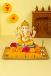 Yellow velvet pooja aasan cloth with golden embroidered border and decorative corner medallions