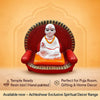 Deity idol on red throne with orange cushion, white robe, and gold-trimmed halo