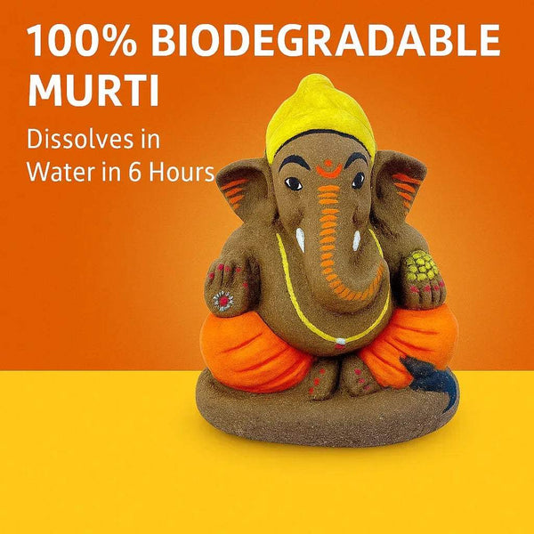 Eco-friendly Ganesha idol with yellow crown, orange dhoti, gray trunk, seated on base
