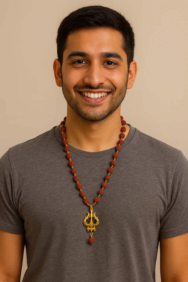 Dark red Rudraksha bead necklace with gold trishool pendant, worn by a smiling man.