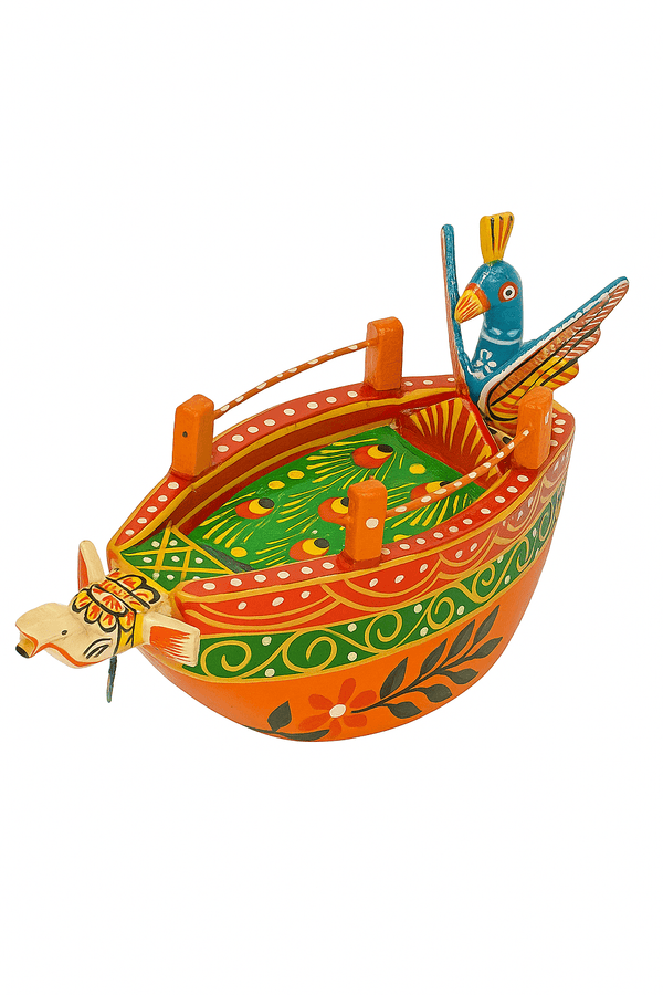 Colorful painted wooden boat with blue bird figures, orange hull, green and red patterns