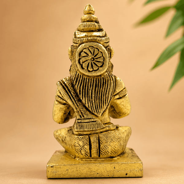 Golden Parvati meditating idol back view, detailed garment and crown, on base