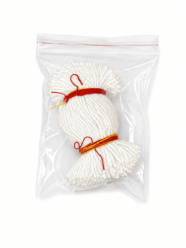White cotton wick bundle with red ties, in clear plastic pouch