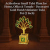 Mini tulsi plant in ornate gold pot with green leaves and swastika-like emblem